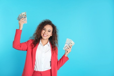Photo of African-American businesswoman with money on color background. Space for text