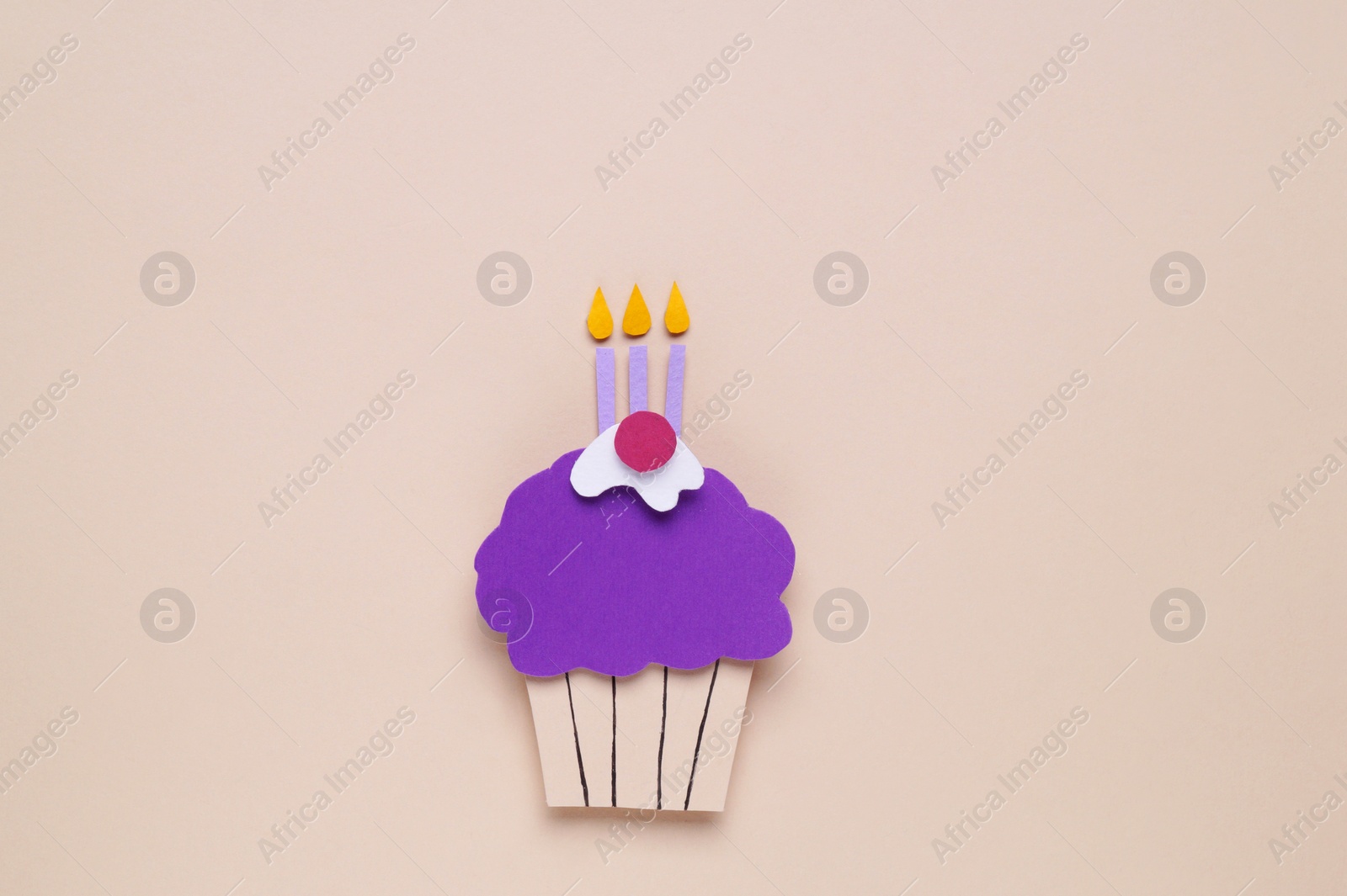 Photo of Birthday party. Paper cupcake with candles on beige background, top view