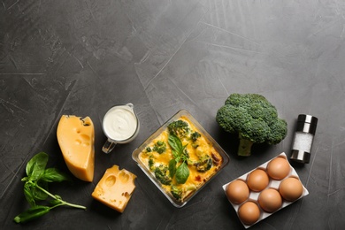 Photo of Flat lay composition with tasty broccoli casserole on grey table. Space for text