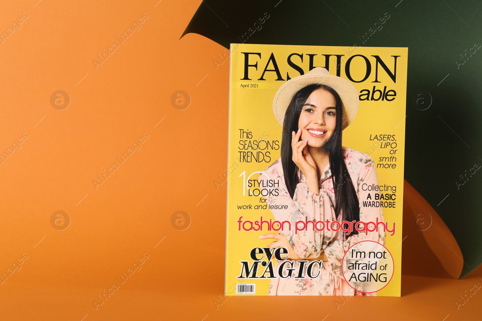 Photo of Modern fashion magazine on color background. Space for text