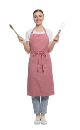 Photo of Beautiful young woman in striped apron with kitchen tools on white background