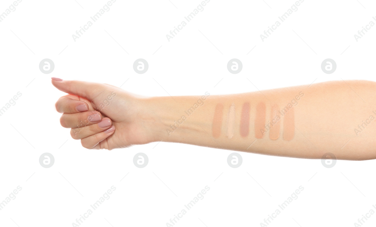 Photo of Woman testing different shades of liquid foundation on her hand against white background, closeup