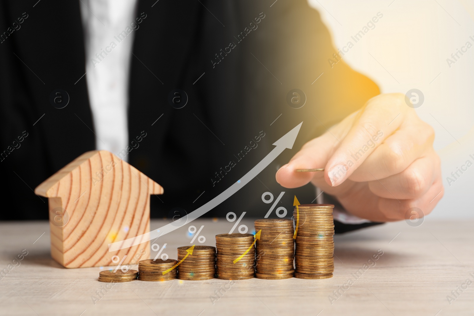 Image of Mortgage rate. Woman stacking coins on table, closeup. Percent signs and arrows