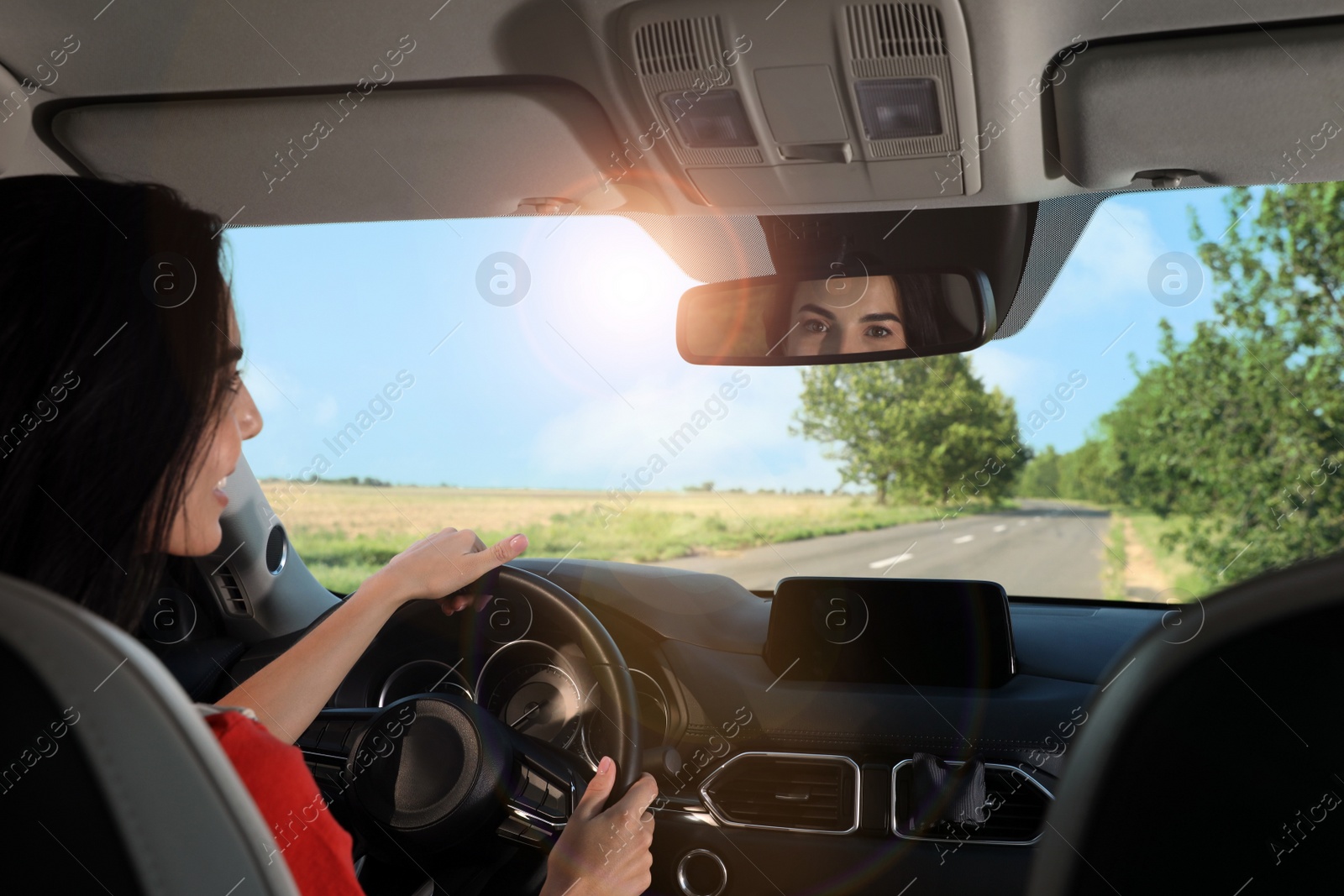 Photo of Beautiful young woman driving her modern car