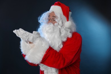 Photo of Man in Santa Claus costume on color background