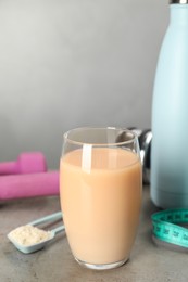 Photo of Tasty shake and powder on gray table, space for text. Weight loss