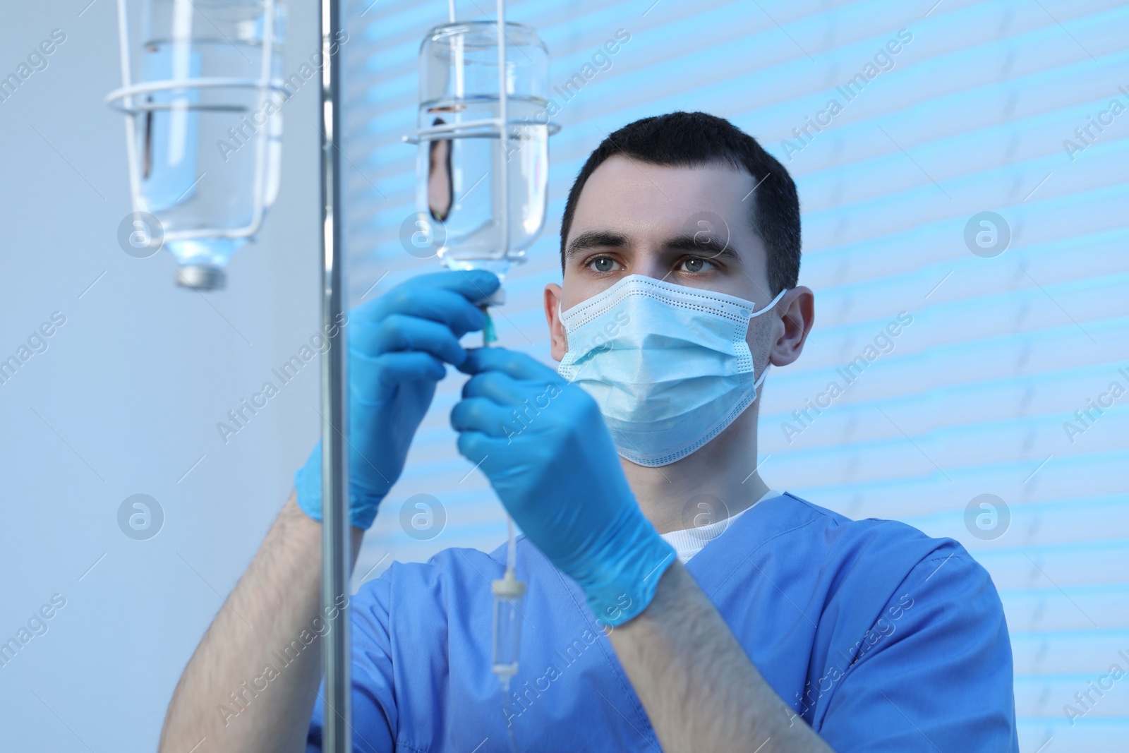 Photo of Nurse setting up IV drip in hospital