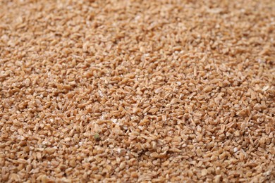 Photo of Dry organic wheat groats as background, closeup