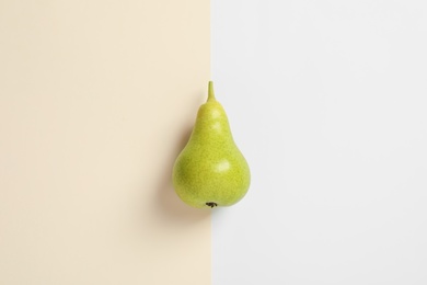 Photo of Ripe juicy pear on color background, top view