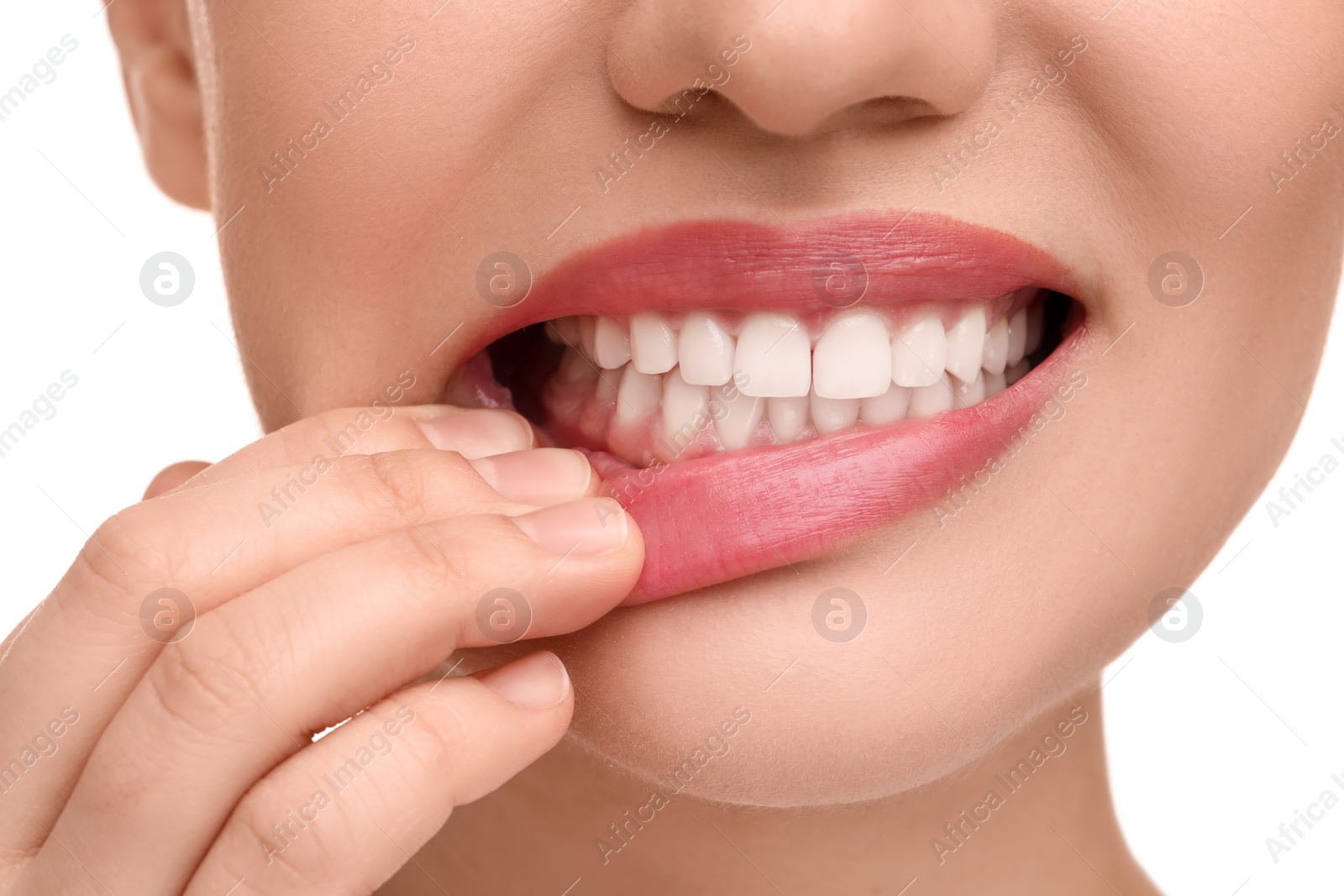 Photo of Woman showing her clean teeth on white background, closeup