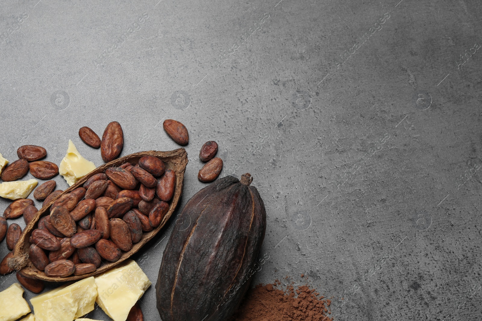 Photo of Flat lay composition with organic cocoa butter on grey table. Space for text