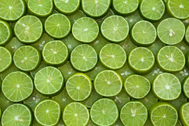 Photo of Fresh lime slices as background, top view