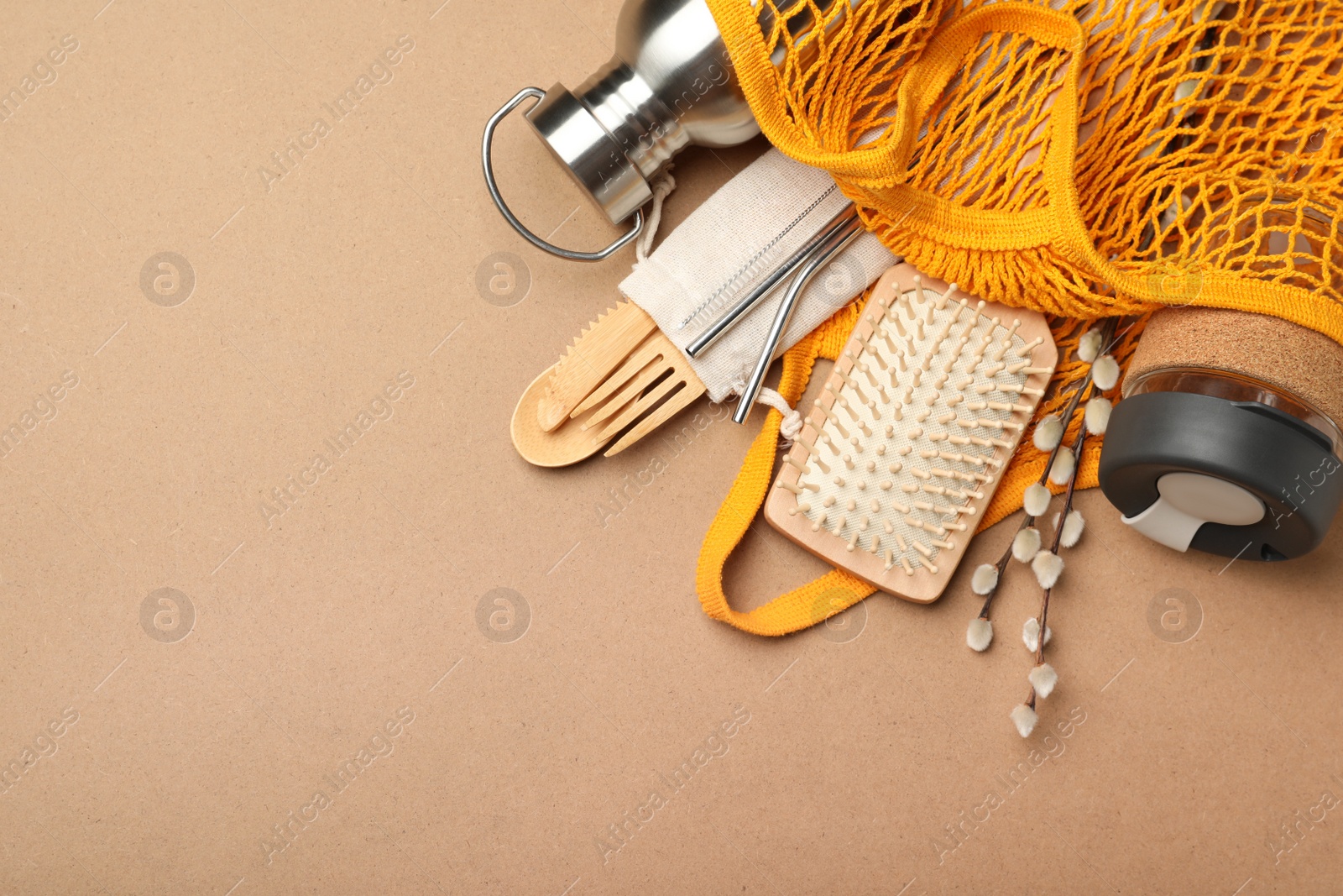 Photo of Bag with eco friendly products on brown background, top view. Space for text