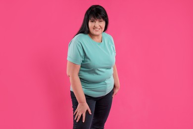 Photo of Beautiful overweight mature woman with charming smile on pink background