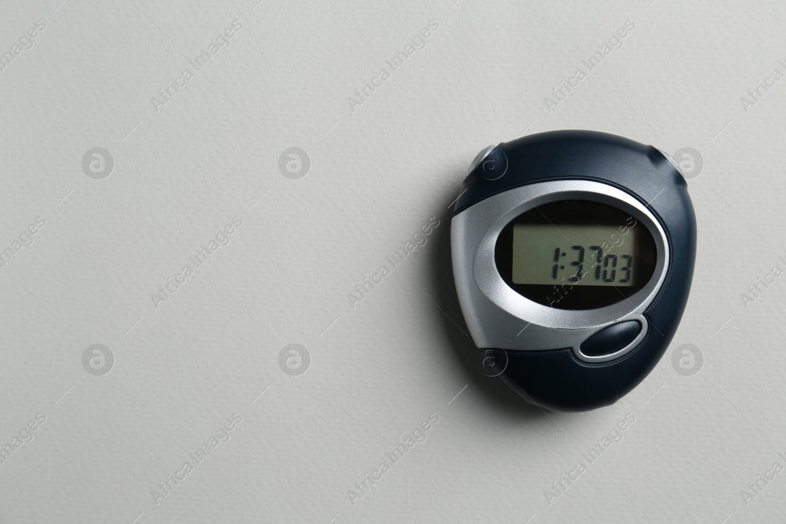 Photo of Digital timer on light grey background, top view. Space for text