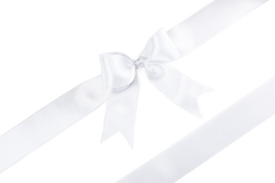 Photo of Satin ribbons with bow on white background, top view