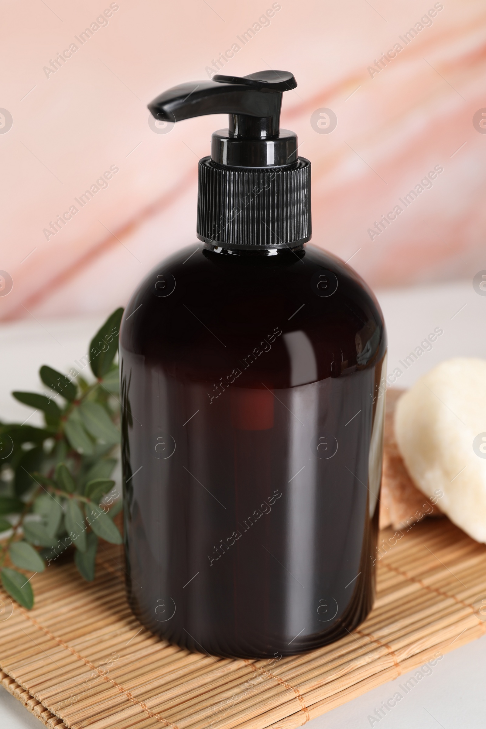 Photo of Shampoo bottle and solid shampoo bars on white marble table