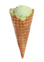 Photo of Waffle cone with sweet pistachio ice cream on white background
