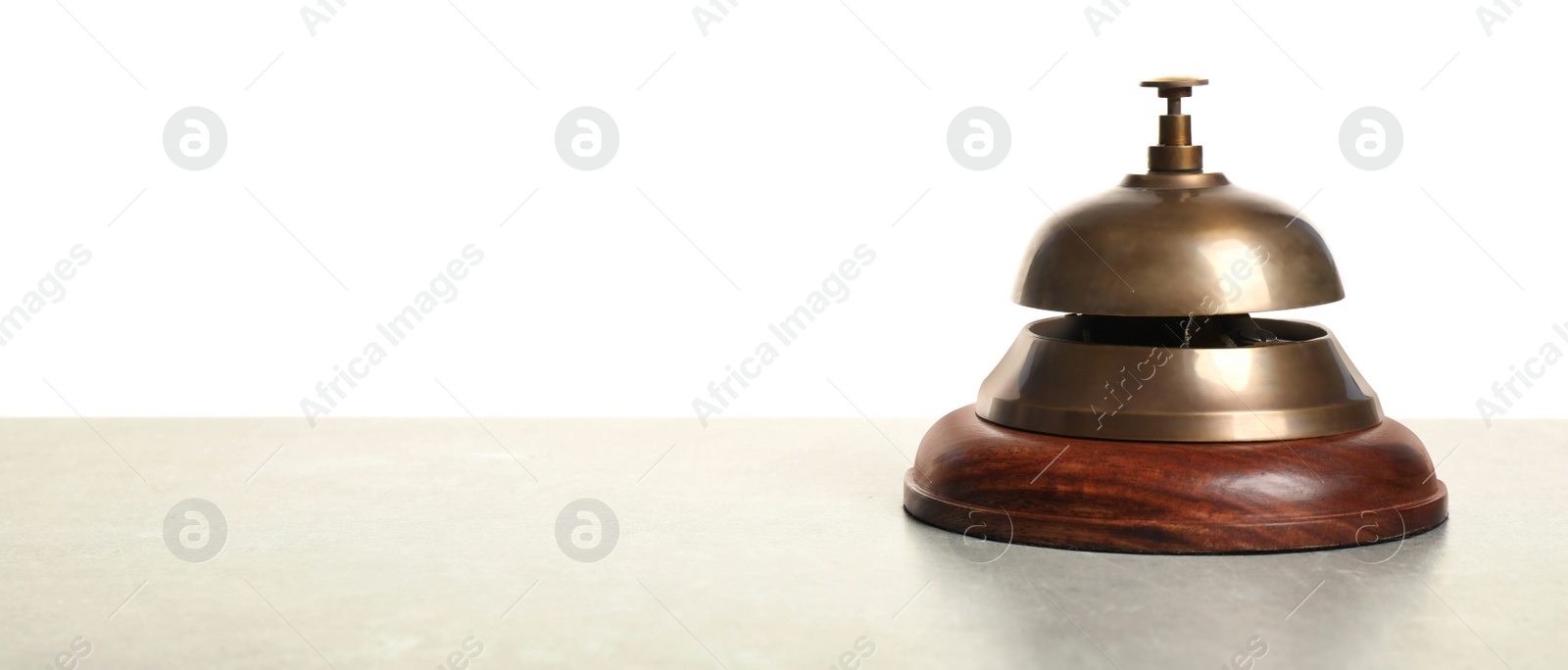 Photo of Hotel service bell on light table against white background