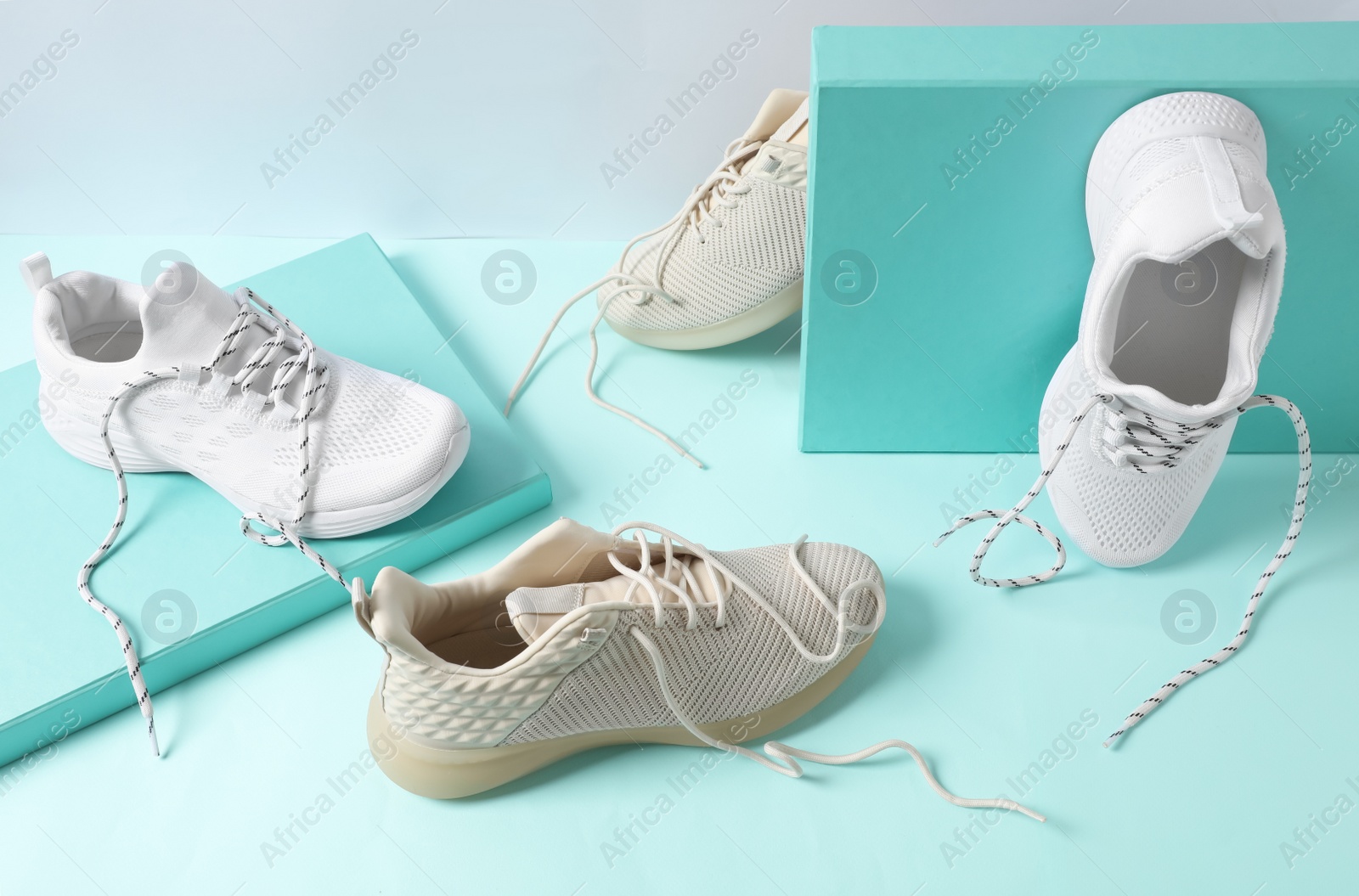 Photo of Stylish shoes with laces on turquoise background
