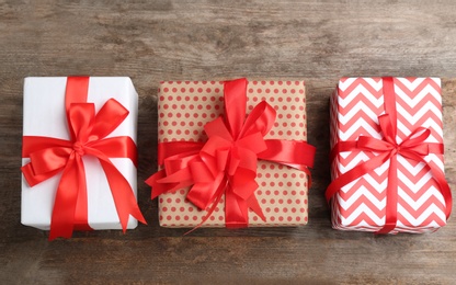 Photo of Different gift boxes on wooden background, flat lay