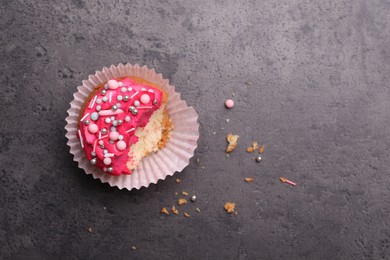 Photo of Failed cupcake and space for text on grey table, top view. Troubles happen