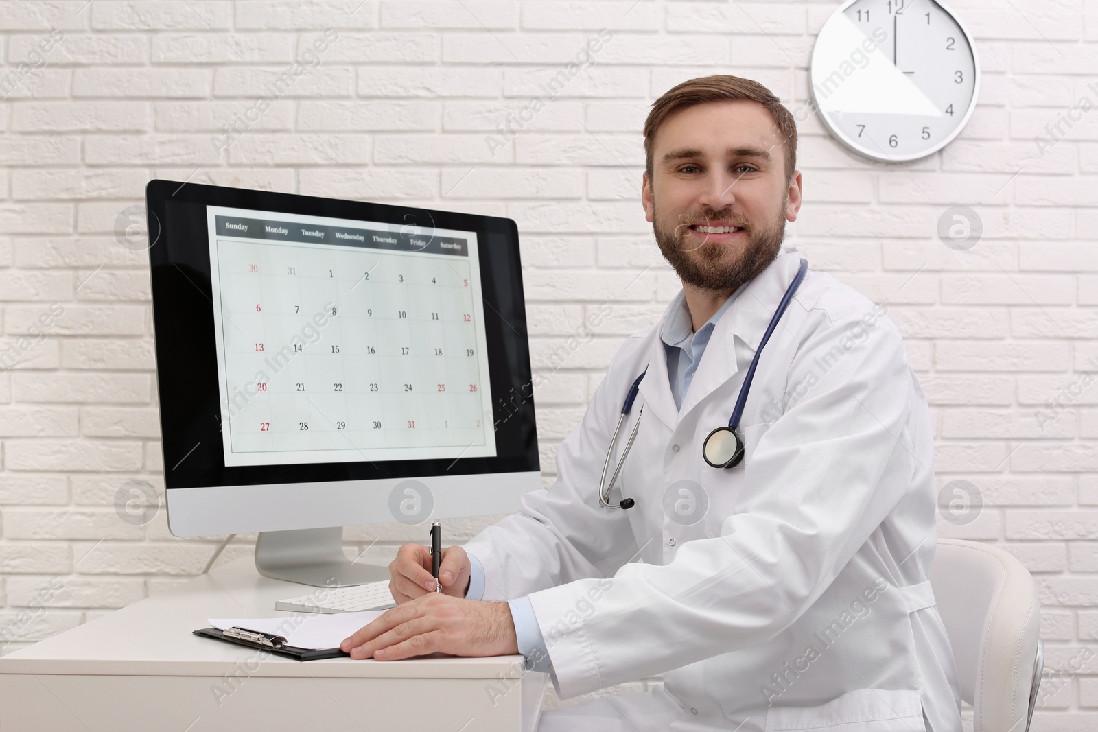 Photo of Portrait of pediatrician at table in clinic