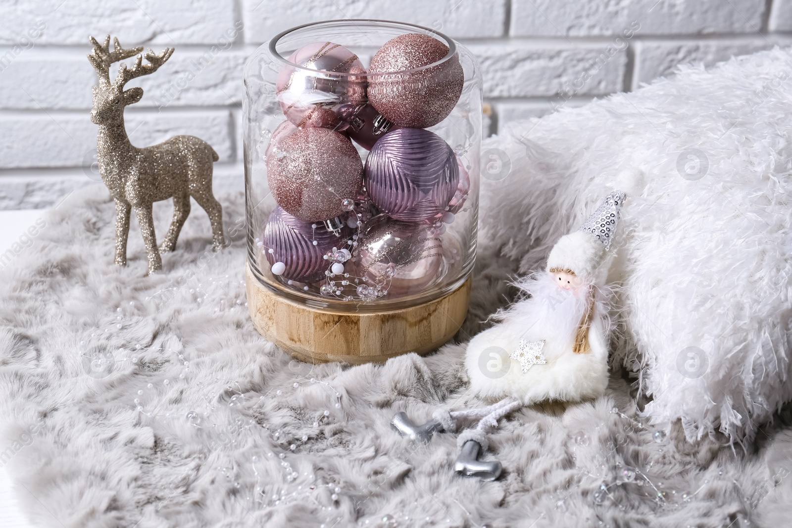 Photo of Composition with beautiful pink Christmas baubles on grey fur