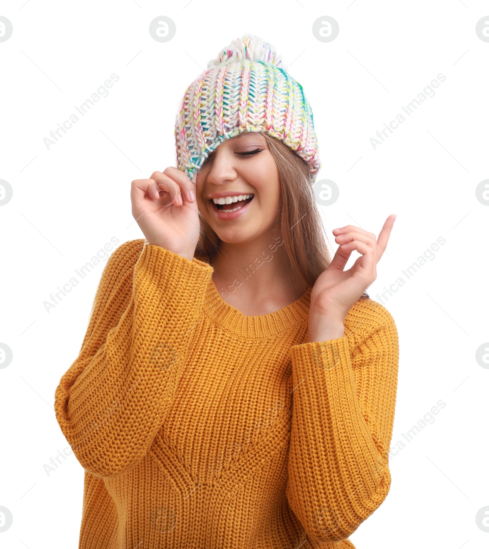 Photo of Funny young woman in warm sweater and hat on white background. Winter season