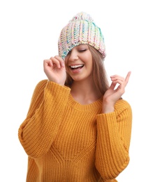 Photo of Funny young woman in warm sweater and hat on white background. Winter season