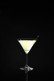 Photo of Glass of delicious cucumber martini on dark background