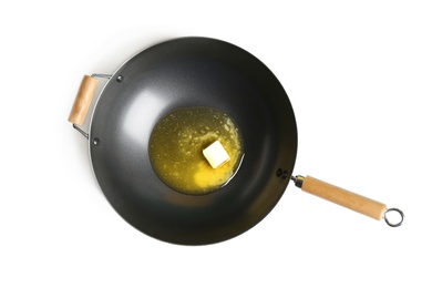 Frying pan with melting butter on white background, top view