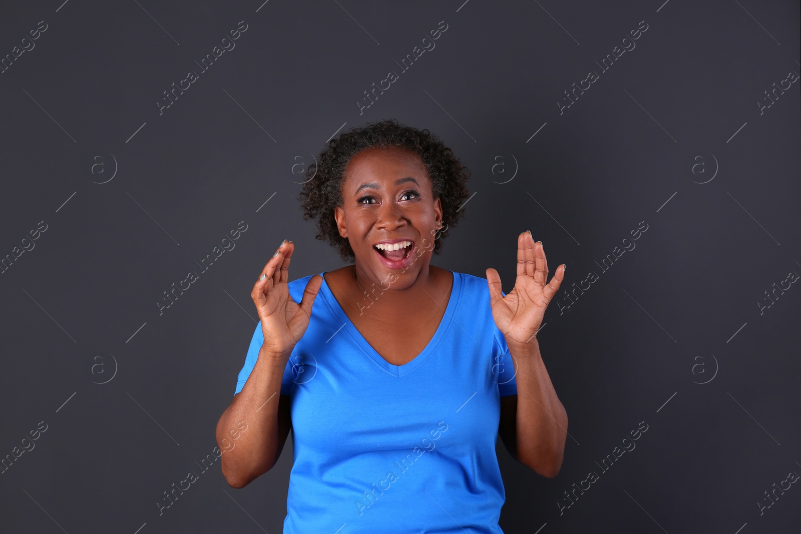 Photo of Portrait of happy African-American woman on black background