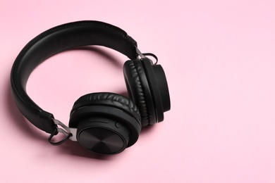 Photo of Stylish headphones on color background. Space for text