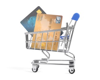 Small metal shopping cart with credit cards isolated on white