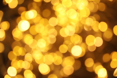 Gold glitter with bokeh effect on dark background