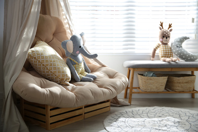 Comfortable armchair in modern baby room interior