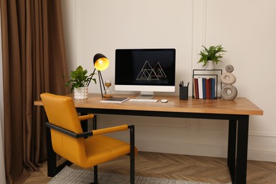 Room interior with comfortable workplace. Modern computer on wooden desk