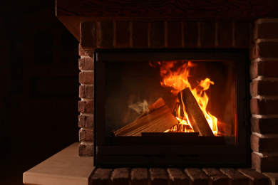 Fireplace with burning wood indoors. Winter vacation