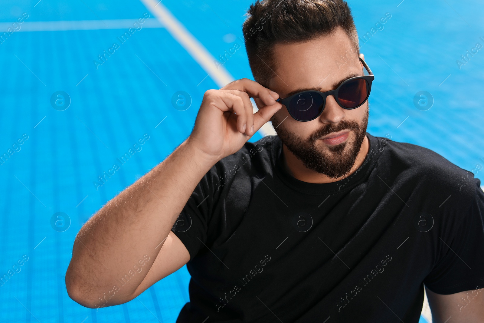 Photo of Handsome man in sunglasses outdoors on sunny day, space for text