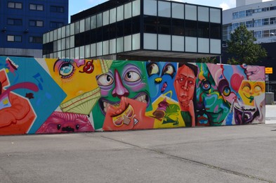 Photo of HAGUE, NETHERLANDS - SEPTEMBER 10, 2022: Colorful graffiti drawn on wall outdoors