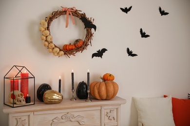 Photo of Fireplace and Halloween decor in room. Idea for festive interior