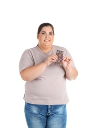 Photo of Overweight woman with chocolate bar on white background