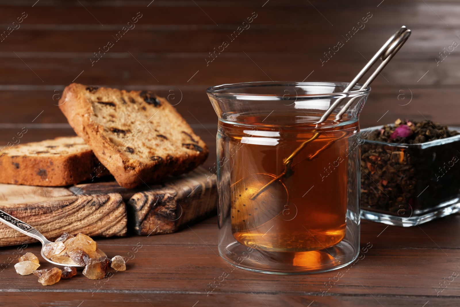 Photo of Composition with hot aromatic tea on wooden background