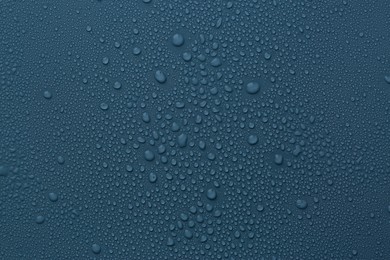 Photo of Many water drops on dark dusty blue background