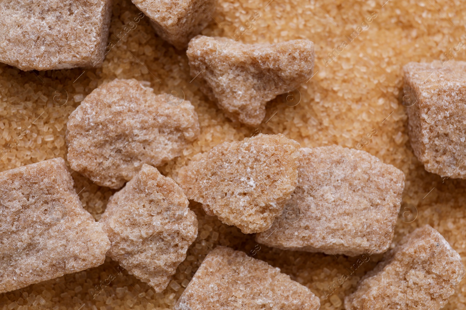 Photo of Refined and granulated brown sugar as background, closeup