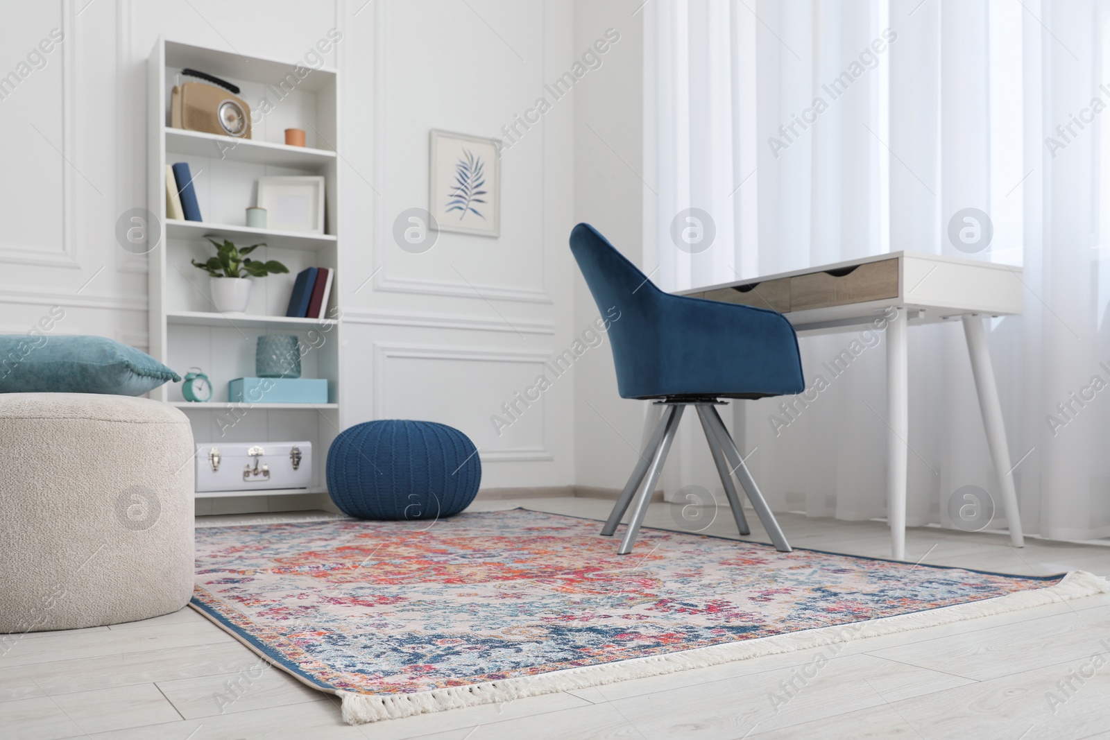 Photo of Stylish room with beautiful rug and furniture. Interior design