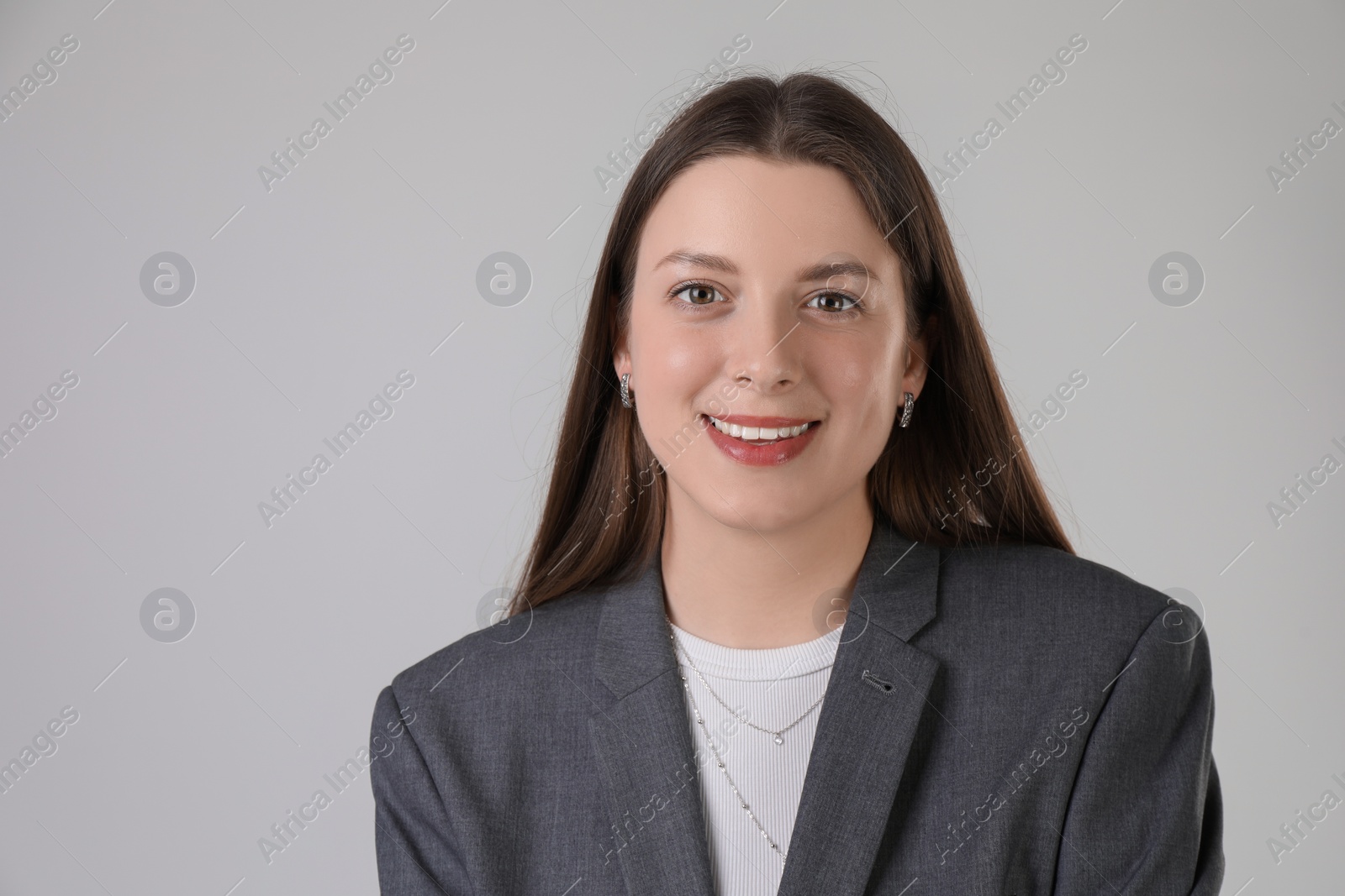 Photo of Portrait of beautiful young woman on light grey background