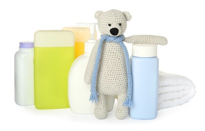 Photo of Set of baby cosmetic products, toy bear and towel on white background