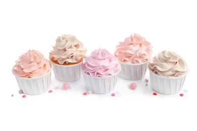 Photo of Tasty cupcakes with cream and sprinkles isolated on white